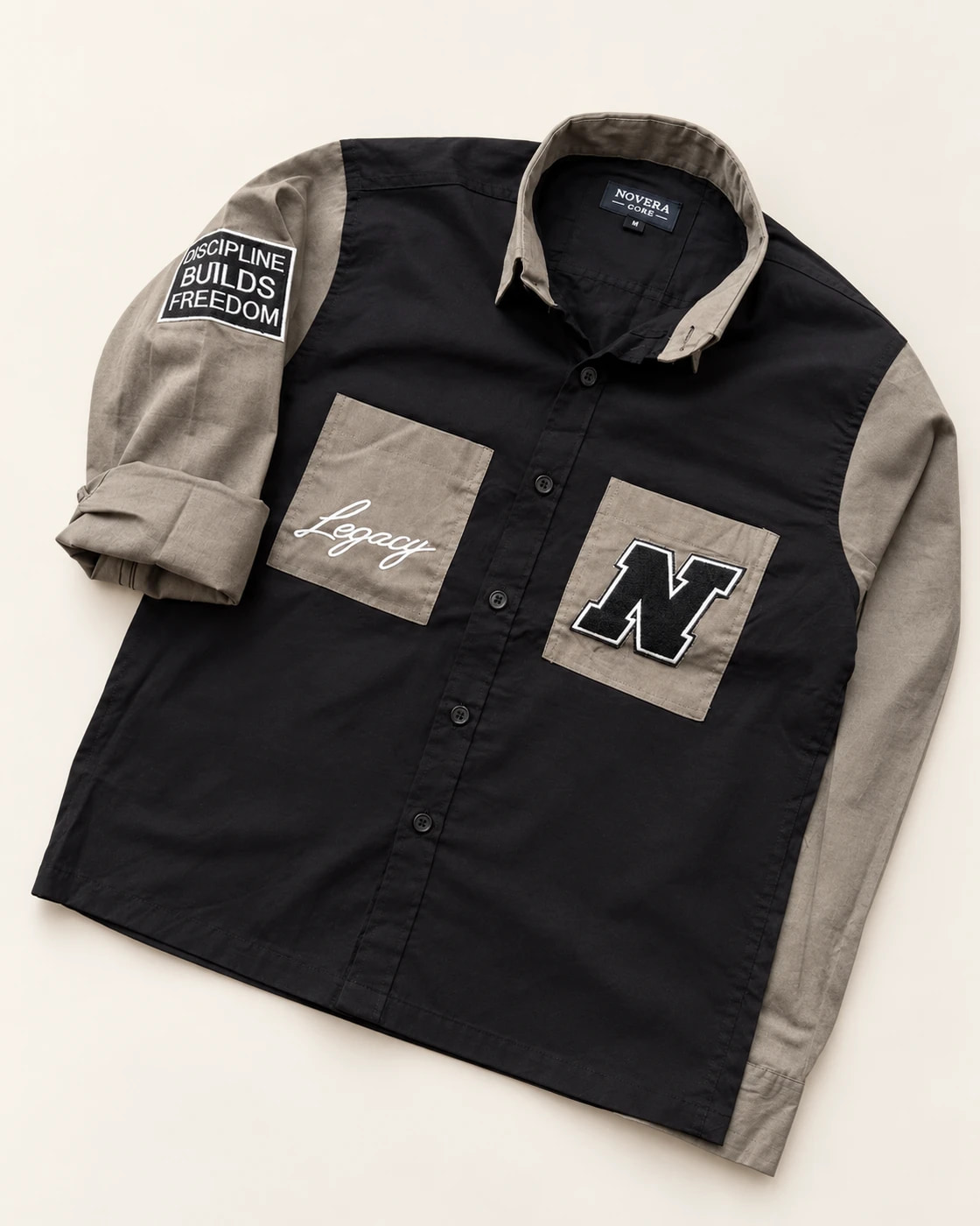 Black and taupe shirt with two flapless pockets, Legacy embroidery, N applique and a sleeve patch