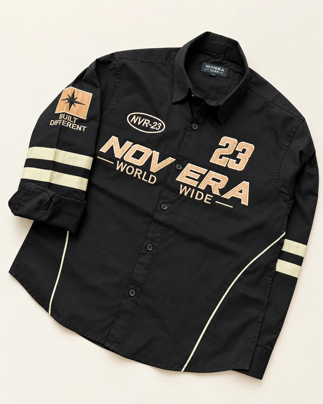 Detail of tan applique, embroidered accents and sleeve bands on an actual black shirt sample